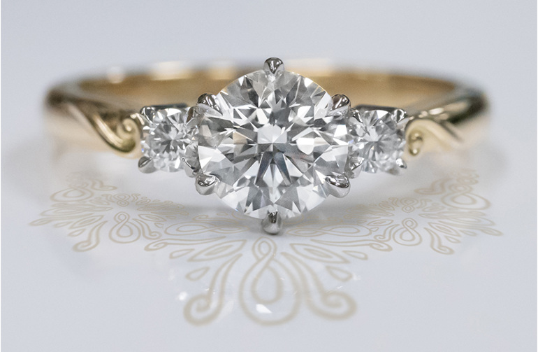 18ct gold platinum diamond three stone engagement ring with koru motif detail