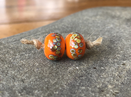 2x handmade glass beads - frit - jitterbug on orange