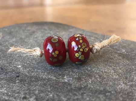 2x handmade glass beads - frit - jitterbug on red