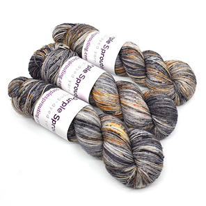 3 skeins of 85/15 merino/nylon in grey, gold & black with speckles