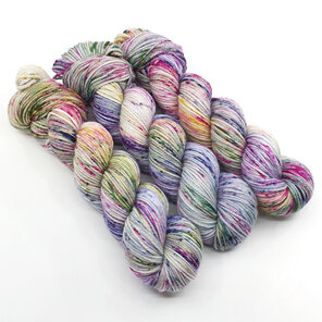 3 skeins of variegated speckled yarn in blue, lilac, purple, green and yellow