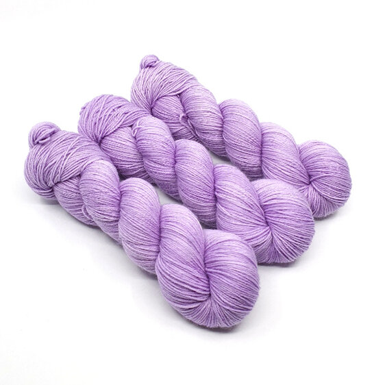 3 twisted skeins of 4ply yarn in light lilac hues