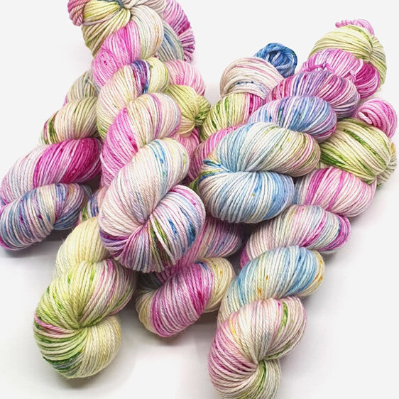 6 skeins of variegated yarn in pink, blue, lilac, green and yellow laid randomly