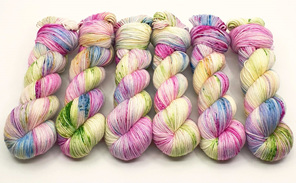 6 twisted skeins of variegated yarn in pink, blue, green, yellow, lilac