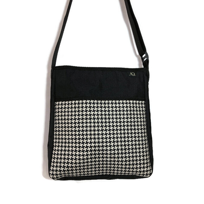 A black and beige handbag in a useful size for everyday work or play.