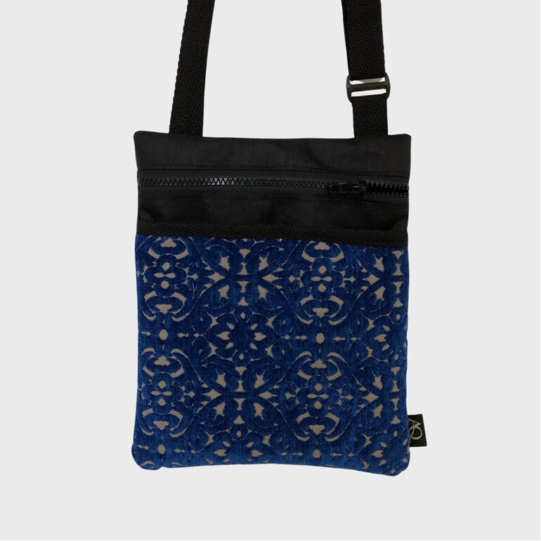 A bright blue textured crossbody bag made for durability and style.