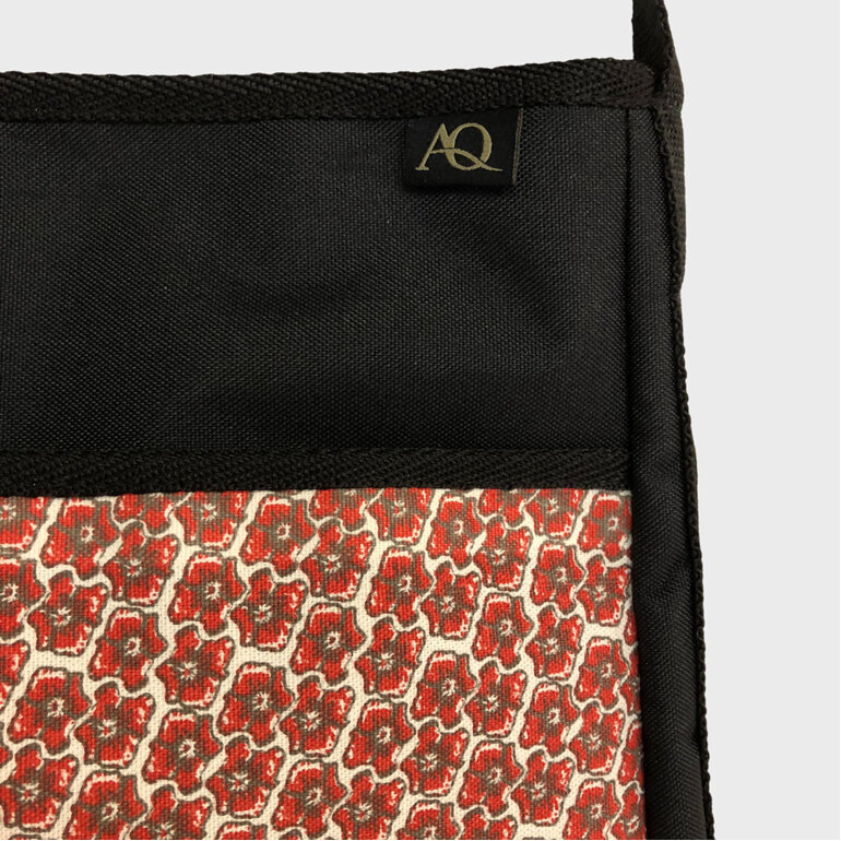 A cute red and grey floral fabric on the front pocket of the everyday handbag