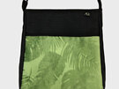 A gree fern and Monstera leaf fabric on the front pocket of the handbag