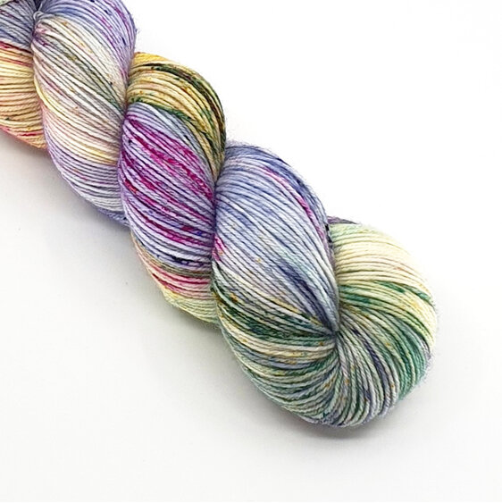 A part skein of variegated speckled yarn in lilac, blue, green, yellow and pink