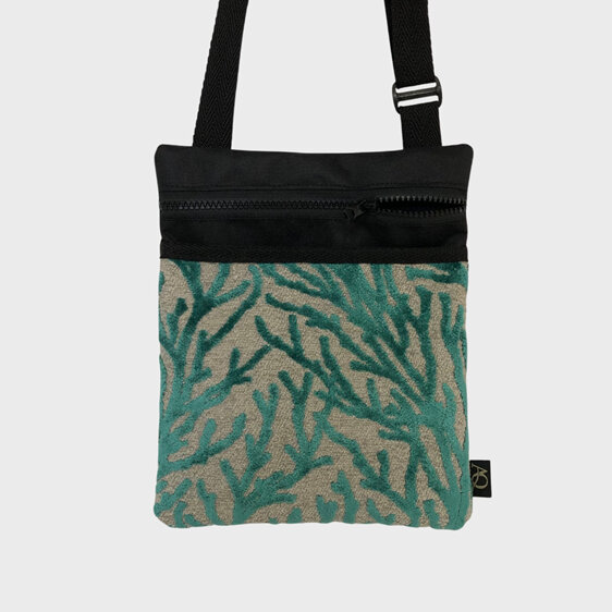 A seaweed fabric on the front pocket of a small crossbody bag