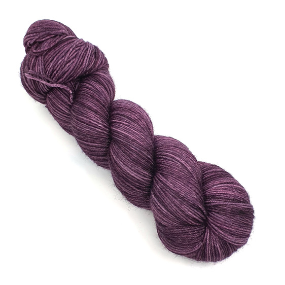 a skein of 85/15 merino/nylon yarn in an aubergine purple tonal colour