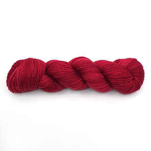 a skein of DK weight 100% merino wool in a semi-solid red