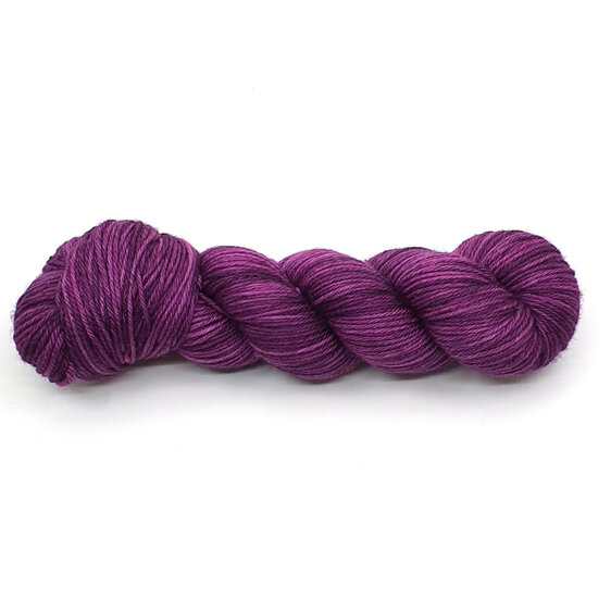 A skein of DK weight 100% merino wool in a tonal purple