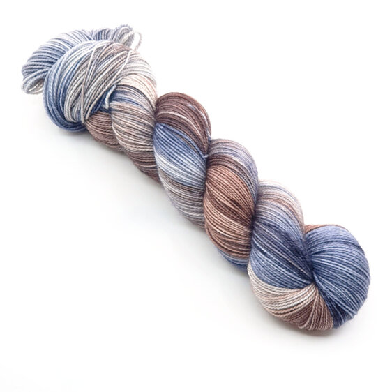 A skein of variegated yarn in subtle brown, blue and grey.