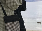 A small handbag in black and white houndstooth fabric