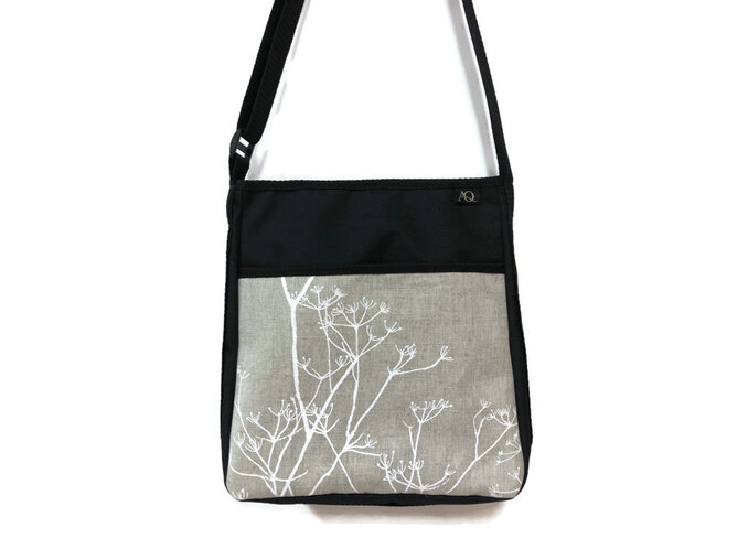 A stylish handbag in natural tones.  Wear it across your body to keep hands free