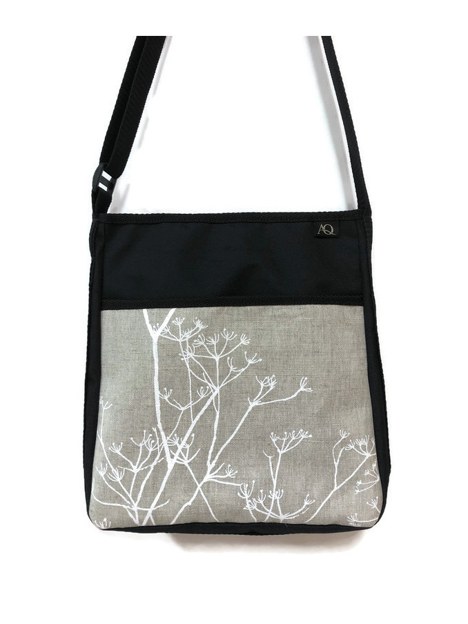 A stylish handbag in natural tones.  Wear it across your body to keep hands free