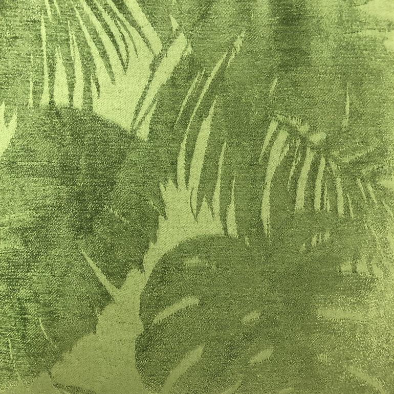 A textured embossed green leaf fabric is featured on the front pocket of the bag
