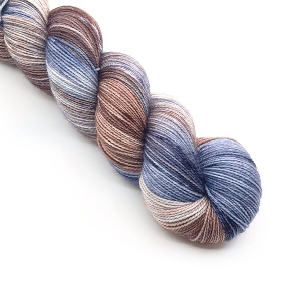 A twisted skein of variegated yarn in subtle brown, blue and grey.
