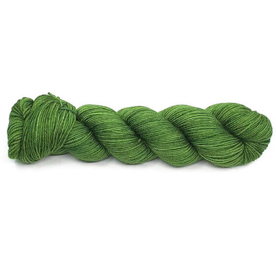 A twisted skein of yarn in green hues laid diagonally on a white background