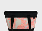 A zipped carryall handbag with a cherry blossom fabric with multiple pockets