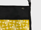 An acorn design in yellow  by Orla Kiely is on the front pocket of this handbag
