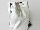 An upcycled sailcloth large duffle bag with stitching detail on the back.