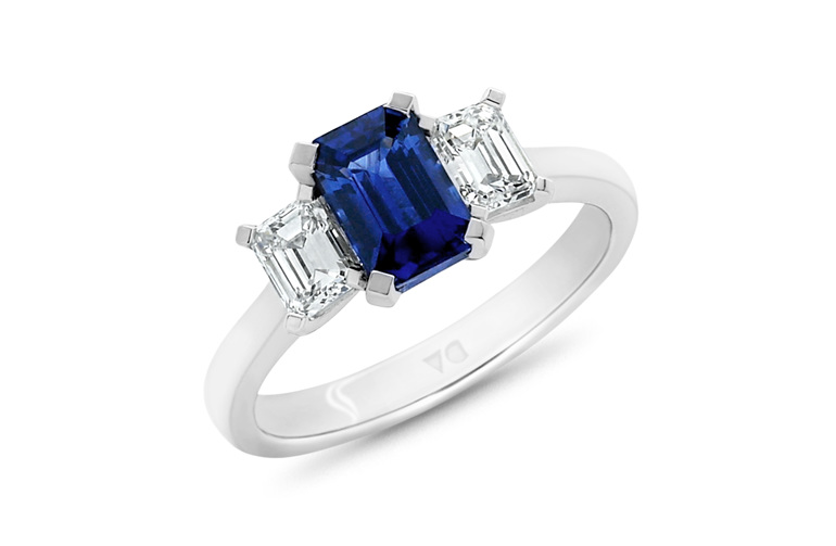Blue emerald cut sapphire and diamond three stone ring platinum white gold