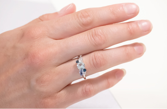 blue gemstone and diamond cluster ring