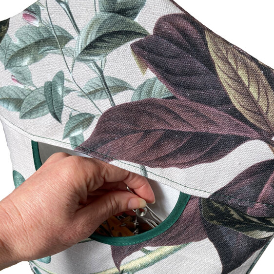 botanical leaves print peg bag with hand reaching in