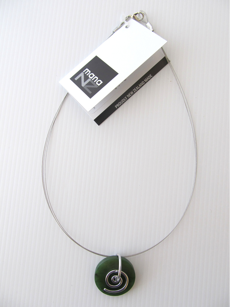 CKA944 Round greenstone pendant with silver koru on silver wire.