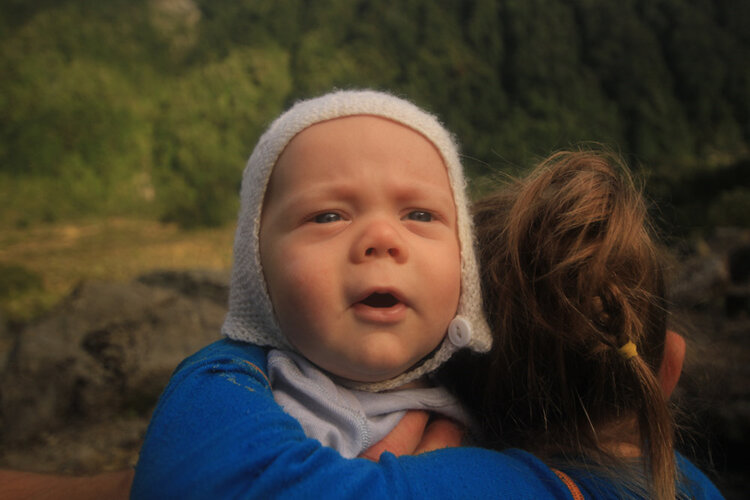 cuddles with baby tramping siblings