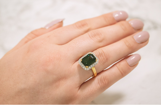 deep green sapphire and diamond halo ring in 18ct yellow gold and platinum