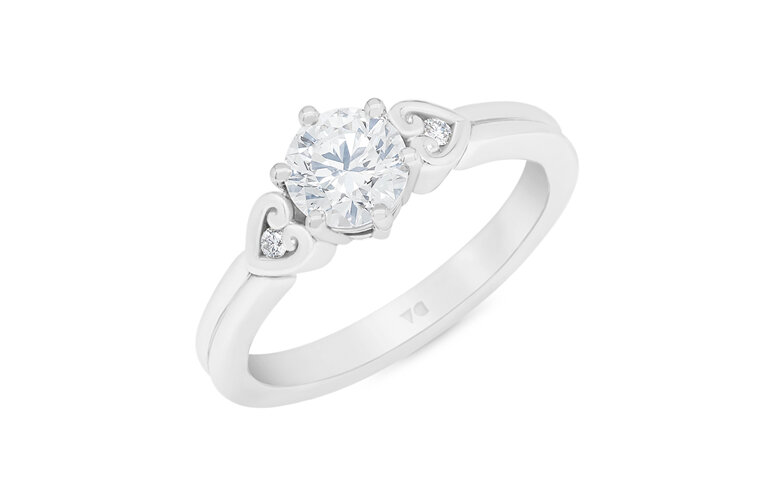 Diamond solitaire engagement ring with koru heart band details platinum gold
