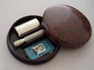 Double edged razor in round bakelite box