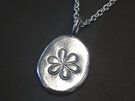 Fine silver nugget pendant with embossed flower detail