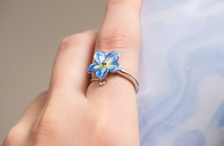 Forget me not blue ring on hand