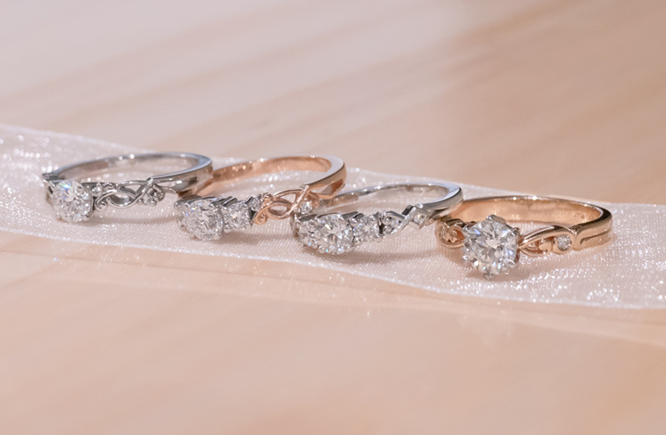 Four rings from the narrative collection, in both white and rose gold.