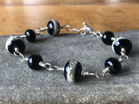 Handmade glass bracelet - pure silver trails - sandstone on black