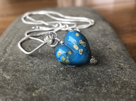 Handmade glass pendant - heart - jitterbug on dark turquoise