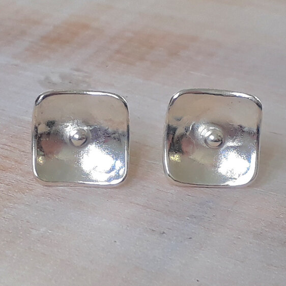 Handmade sterling silver stud earrings with central silver ball