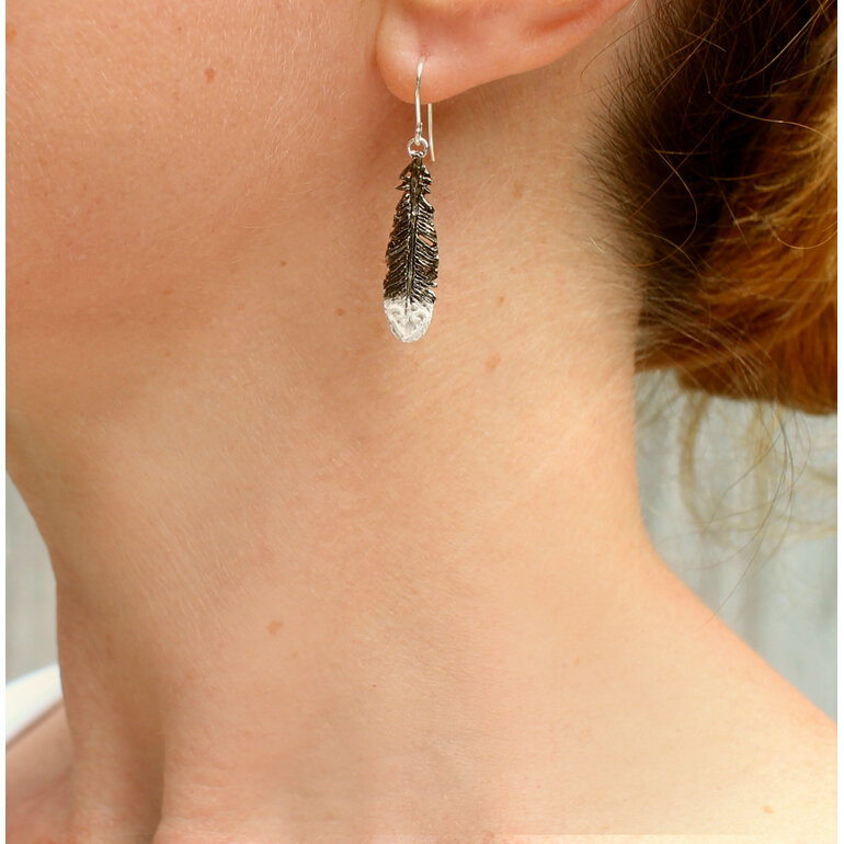 huia feather black white sterling silver native  earrings worn koru lily griffin