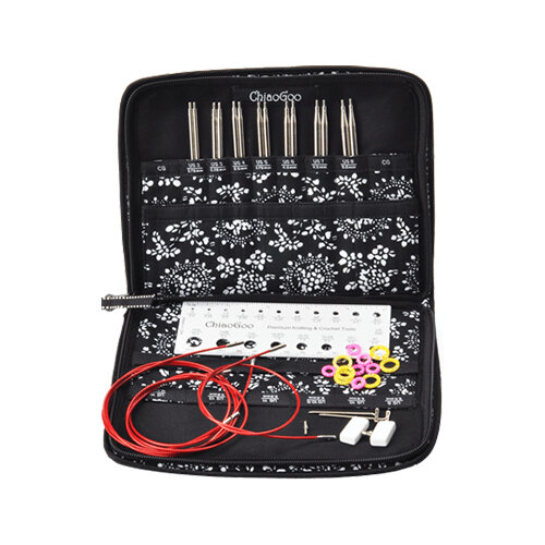 image is a zip up case holding 6 sets of needle tips, red cable, stitch markers