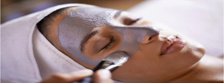 image of woman having a face mask applied