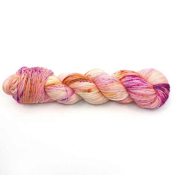 Image shows a twisted skein of yarn in cream, pink and gold colours