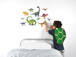 Large dinosaur wall decal with child applying it to the wall