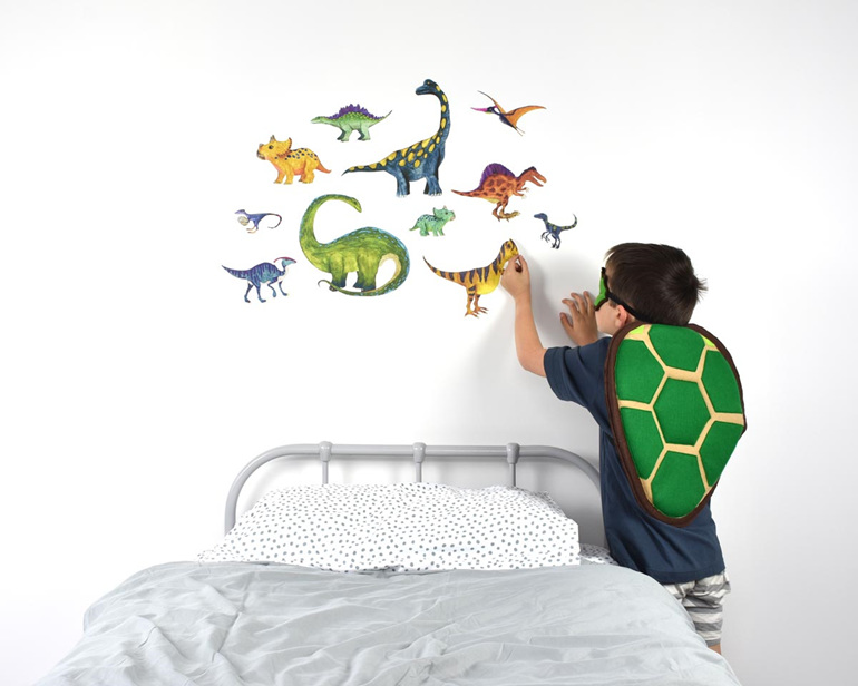 Large dinosaur wall decal with child applying it to the wall
