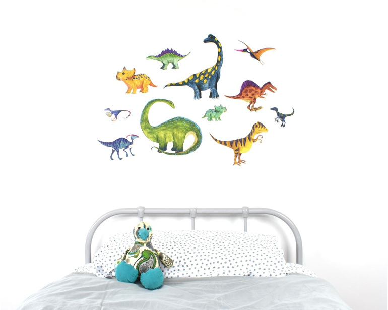 Large dinosaur wall decal with kiwi soft toy on bed