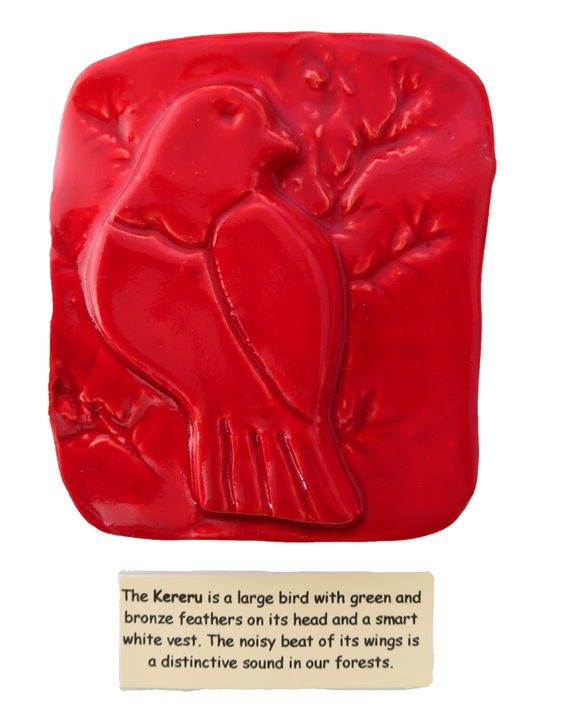 Little red ceramic tile of a Kereru bird