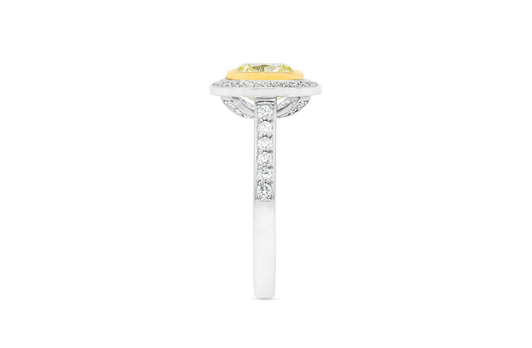 Natural Fancy Yellow diamond framed in yellow gold, surrounded by 44 diamonds